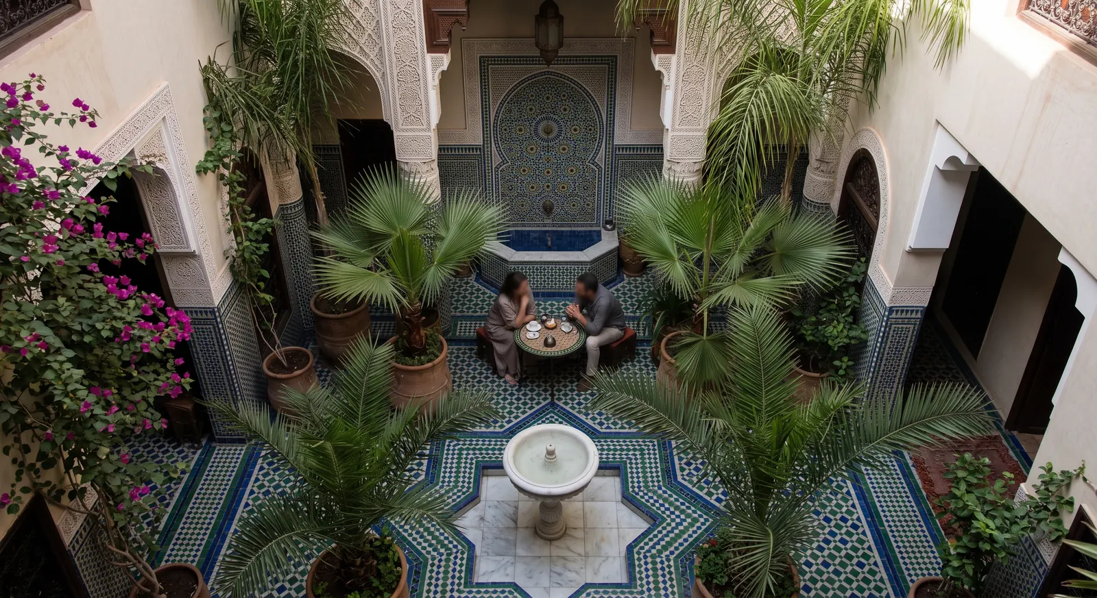 Peaceful Marrakech riad courtyard with blue zellige tilework and palm trees